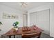 Well-lit bedroom featuring a desk and airplane art above, complete with stylish light fixture and closet at 1154 64Th S Ave, St Petersburg, FL 33705