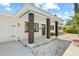 Inviting front porch with stylish pillars, a modern front door, and well-manicured landscaping at 1154 64Th S Ave, St Petersburg, FL 33705