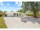 Inviting single-story home with a well-maintained lawn and long driveway leading to the attached garage at 1154 64Th S Ave, St Petersburg, FL 33705