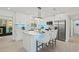 Modern kitchen with white cabinetry, stainless steel appliances, and a stylish island with bar seating at 1154 64Th S Ave, St Petersburg, FL 33705