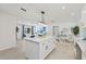 Open-concept kitchen with a large island, stainless steel appliances, and seamless flow to the living area at 1154 64Th S Ave, St Petersburg, FL 33705