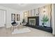 Living room featuring an art deco fireplace, with decorative wallpaper and contemporary furnishings at 1154 64Th S Ave, St Petersburg, FL 33705