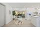 Stylish living room with a glass table, an art deco fireplace, and an open view to the kitchen at 1154 64Th S Ave, St Petersburg, FL 33705