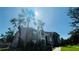 Exterior of a multi-story building with lush landscaping and mature palm trees at 10200 Gandy N Blvd # 405, St Petersburg, FL 33702