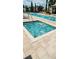 A close up view of a hot tub surrounded by deck and a pool running along the back side at 10200 Gandy N Blvd # 405, St Petersburg, FL 33702