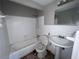 Damaged bathroom featuring an old bathtub, toilet, and sink awaiting renovation at 1501 Delaware Ne Ave, St Petersburg, FL 33703