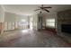Bright living room with ceiling fan, fireplace, and large windows, showing exposed framework at 1501 Delaware Ne Ave, St Petersburg, FL 33703