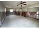 Spacious living room featuring ceiling fans, bright windows and exposed wall studs showcasing remodel potential at 1501 Delaware Ne Ave, St Petersburg, FL 33703