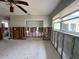 Bright living room with large window, ceiling fan, and exposed wall studs highlighting renovation opportunity at 1501 Delaware Ne Ave, St Petersburg, FL 33703
