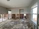 Bright living room with windows and exposed wall studs offering renovation potential at 1501 Delaware Ne Ave, St Petersburg, FL 33703