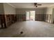 Open-concept space with open door to backyard undergoing renovations and exposed framework at 1501 Delaware Ne Ave, St Petersburg, FL 33703
