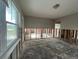 Partially renovated living room featuring bright windows and exposed wall studs showcasing remodel potential at 1501 Delaware Ne Ave, St Petersburg, FL 33703