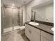 Bathroom featuring granite countertop vanity and glass shower at 1526 Cassius St, Lutz, FL 33549