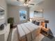 Cozy bedroom featuring a comfortable bed, stylish decor, ceiling fan, and a bright window view at 1526 Cassius St, Lutz, FL 33549