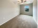 Comfortable bedroom with plush carpeting, a window offering natural light, and neutral walls at 1526 Cassius St, Lutz, FL 33549