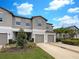 Inviting townhouse with manicured lawn, convenient parking, and pleasing exterior paint scheme at 1526 Cassius St, Lutz, FL 33549