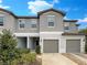 Charming townhouse with well-maintained landscaping, attached garage, and welcoming curb appeal at 1526 Cassius St, Lutz, FL 33549