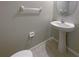Cozy half bathroom with a pedestal sink and a round mirror at 1526 Cassius St, Lutz, FL 33549