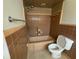 Retro bathroom featuring tan tile walls, bath tub and vintage fixtures at 1998 Cove Dr, Largo, FL 33774