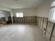 Spacious bedroom undergoing renovation with exposed concrete walls and ample natural light at 1998 Cove Dr, Largo, FL 33774
