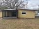 Back exterior view with small window at 411 Shore E Dr, Oldsmar, FL 34677