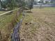 Fenced-in backyard with a mix of grass and bare ground at 411 Shore E Dr, Oldsmar, FL 34677
