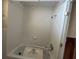 White tiled bathroom with a bathtub and shower head at 411 Shore E Dr, Oldsmar, FL 34677