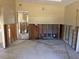 Living room undergoing renovation with exposed studs and no flooring at 411 Shore E Dr, Oldsmar, FL 34677