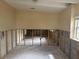 Unfinished room with tile flooring and exposed wall framing at 411 Shore E Dr, Oldsmar, FL 34677