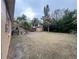 Expansive backyard features a shed and tropical trees, providing a private outdoor area with potential for landscaping at 4200 Huntington Ne St, St Petersburg, FL 33703