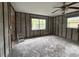 Another view of the spacious room showcasing windows and ceiling fan; a perfect space to transform at 4200 Huntington Ne St, St Petersburg, FL 33703