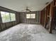 A large room with exposed framing, windows, and a ceiling fan, ready for interior design ideas at 4200 Huntington Ne St, St Petersburg, FL 33703