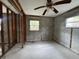 Unfinished room with block walls, wood frame supports, ceiling fan, and window at 4200 Huntington Ne St, St Petersburg, FL 33703