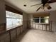 Image shows a room in need of renovation with block walls and a ceiling fan at 6915 N River Blvd, Tampa, FL 33604