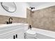 Tiled bathroom featuring a white vanity, updated fixtures, a toilet, and a shower/tub combo at 2353 Shelley St # 6, Clearwater, FL 33765