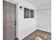 Neutral entryway features a gray door, stylish lighting, and wood-look flooring at 2353 Shelley St # 6, Clearwater, FL 33765