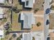 Aerial view of the property with a new gray roof, gravel front yard, and fenced backyard at 3630 Winder Dr, Holiday, FL 34691