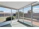 View from inside the screened lanai looking out at the backyard and surrounding trees at 3630 Winder Dr, Holiday, FL 34691