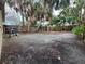 Large backyard featuring dirt, grass, mature trees, and a full wood fence providing privacy and seclusion at 4247 Helena Ne St, St Petersburg, FL 33703