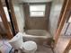 Under-construction bathroom featuring a new bathtub and toilet awaiting finishing touches for a custom design at 4247 Helena Ne St, St Petersburg, FL 33703