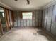 The unfinished main bedroom with window and exposed block awaits personalized design and renovation at 4247 Helena Ne St, St Petersburg, FL 33703