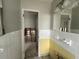 Bathroom featuring white and yellow tiles and bright mirror, a blank canvas for a new design at 4435 Huntington Ne St, St Petersburg, FL 33703