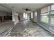 Open-concept living room with large windows and ceiling fan, ready to remodel at 4435 Huntington Ne St, St Petersburg, FL 33703