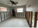 Spacious room featuring a ceiling fan and bright windows, ready for customization and renovation at 4435 Huntington Ne St, St Petersburg, FL 33703