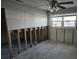 Bedroom with exposed studs, ceiling fan and natural light awaiting renovation and personal touch at 4706 Lansing Ne St, St Petersburg, FL 33703