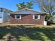 Brick home with tidy backyard featuring well maintained lawn at 4706 Lansing Ne St, St Petersburg, FL 33703