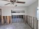 Spacious living room ready for renovation, featuring a ceiling fan and natural light at 4706 Lansing Ne St, St Petersburg, FL 33703