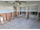 Spacious living room ready for renovation, featuring a ceiling fan and natural light at 4706 Lansing Ne St, St Petersburg, FL 33703