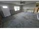 Spacious living room with ceiling fan awaiting renovation and restoration to its former glory at 4706 Lansing Ne St, St Petersburg, FL 33703