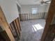 Spacious living room ready for renovation, featuring a ceiling fan and natural light at 4706 Lansing Ne St, St Petersburg, FL 33703